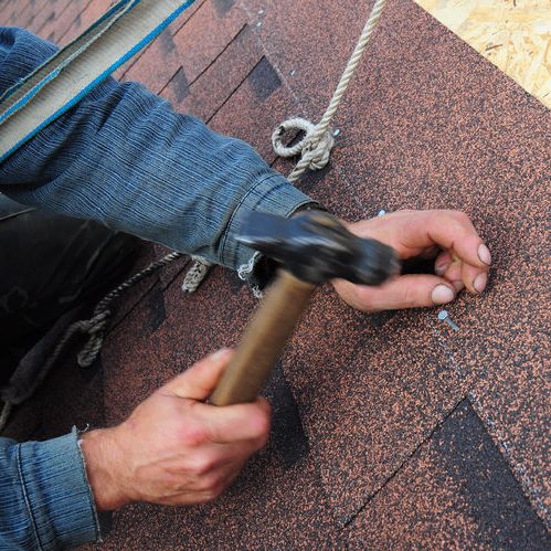 Close Up of Roofer Installing Asphalt Shingles